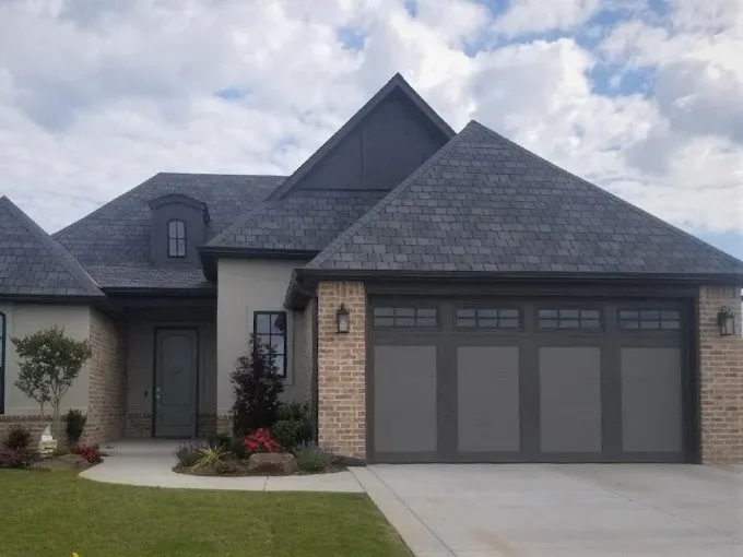 Premium dark recessed panel garage door on luxury home by Affordable Door Co OKC