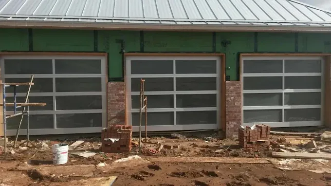 Full-view frosted glass garage doors on new construction installed by Affordable Door Co OKC